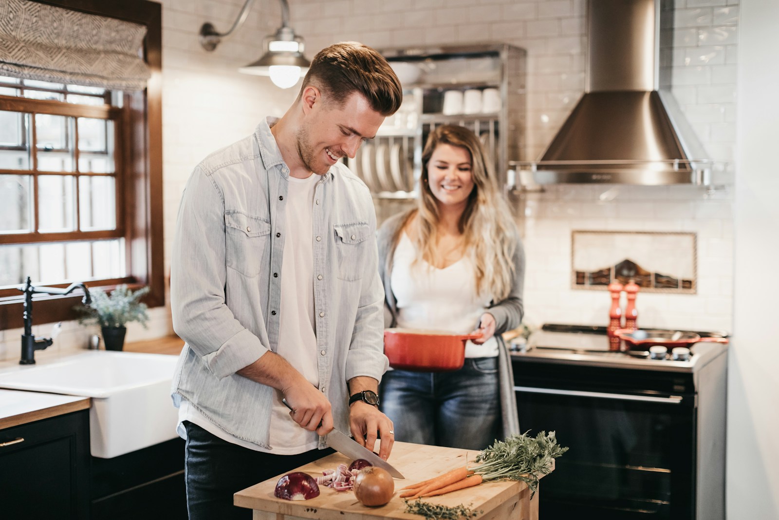 Couple enjoying their new white kitchen together